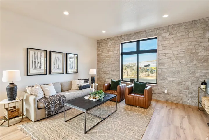 Living room with light wood finished floors and recessed lighting