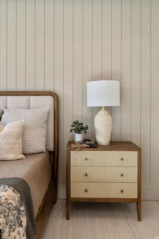 Bedroom featuring light carpet