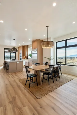 Dining room featuring plenty of natural light, light wood-type flooring, recessed lighting, and a mountain view