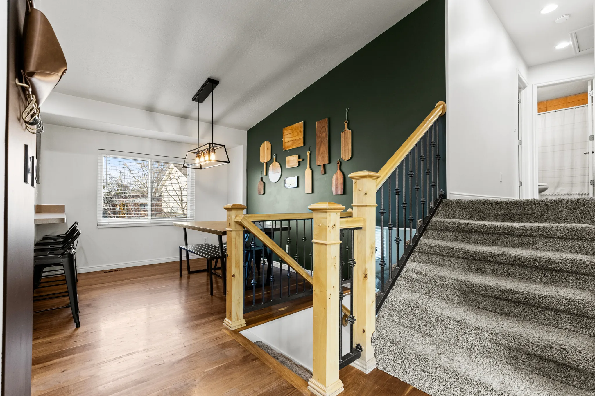 Stairway with baseboards and wood finished floors