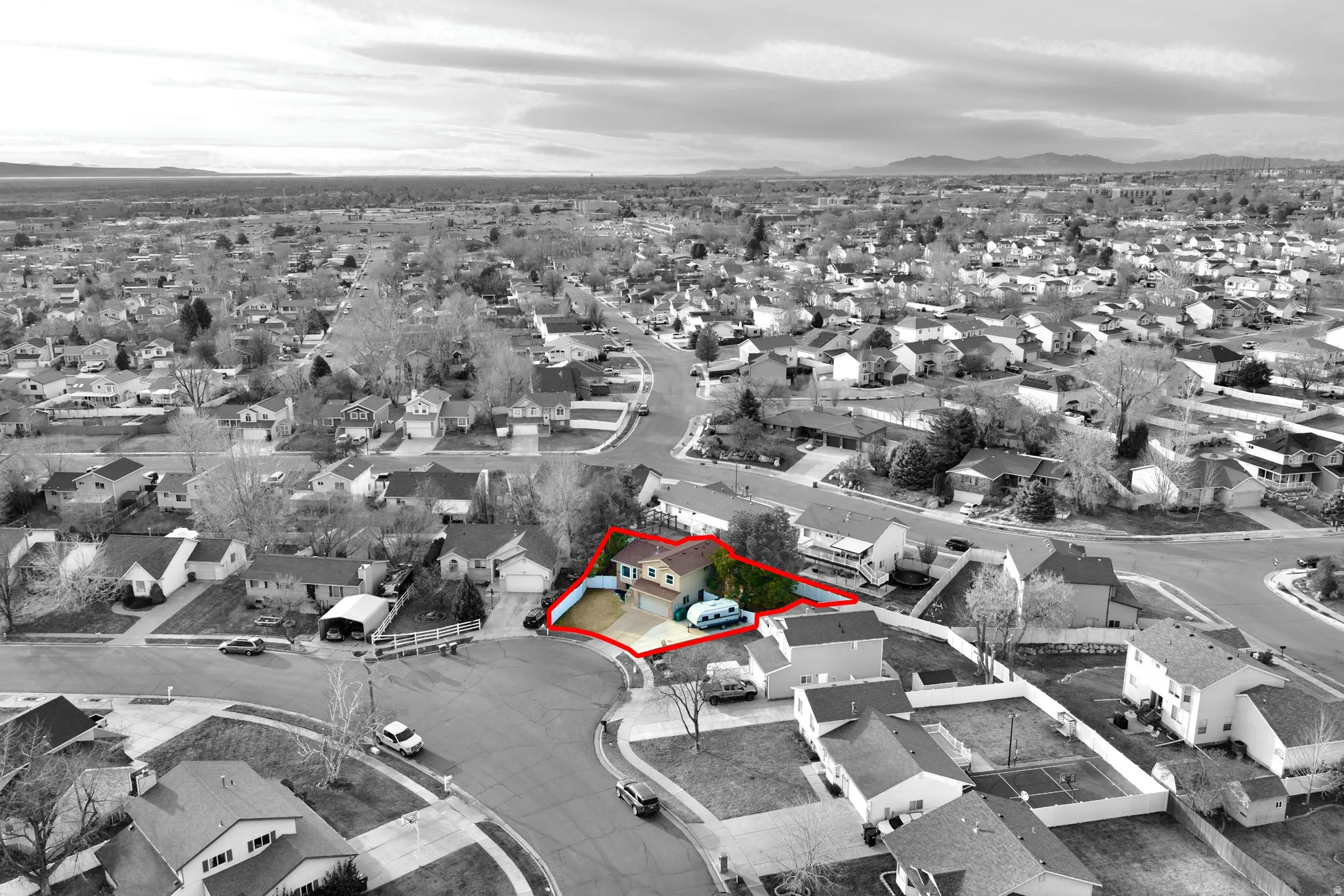 Aerial view of residential area featuring property boundaries highlighted