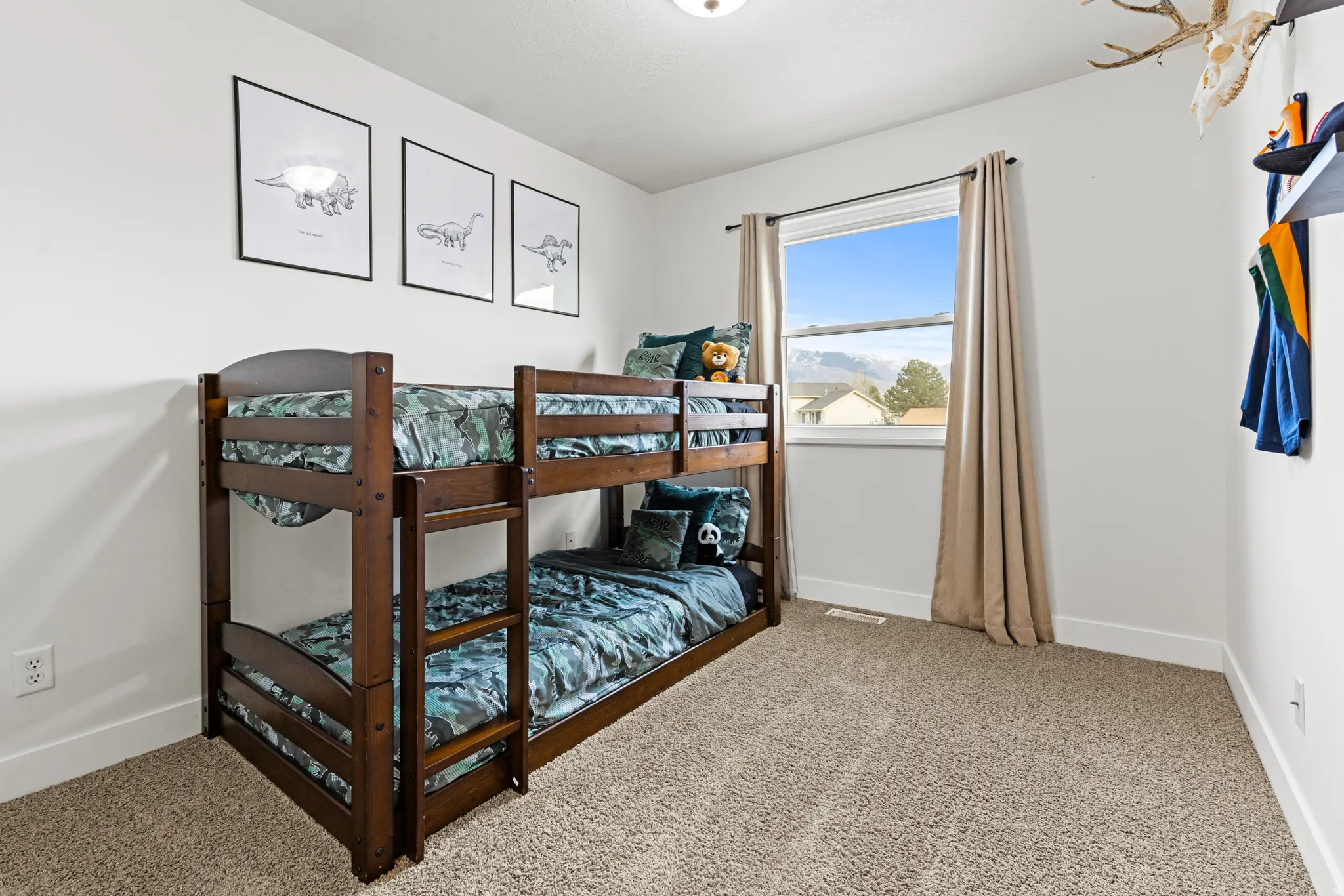 Bedroom featuring baseboards and light colored carpet