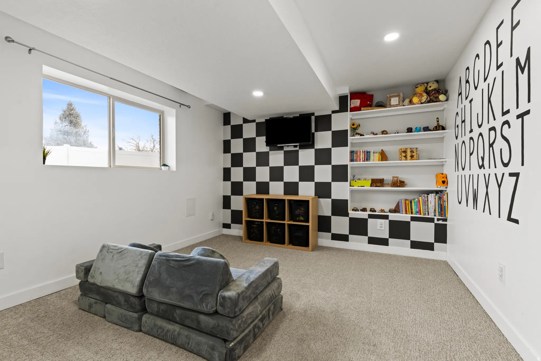 Sitting room featuring an accent wall, recessed lighting, and light carpet