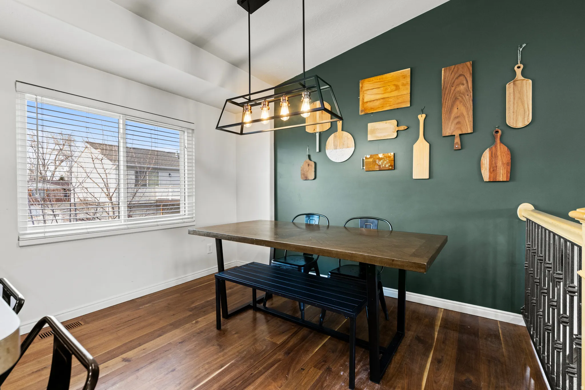 Dining room featuring dark wood-style flooring and vaulted ceiling