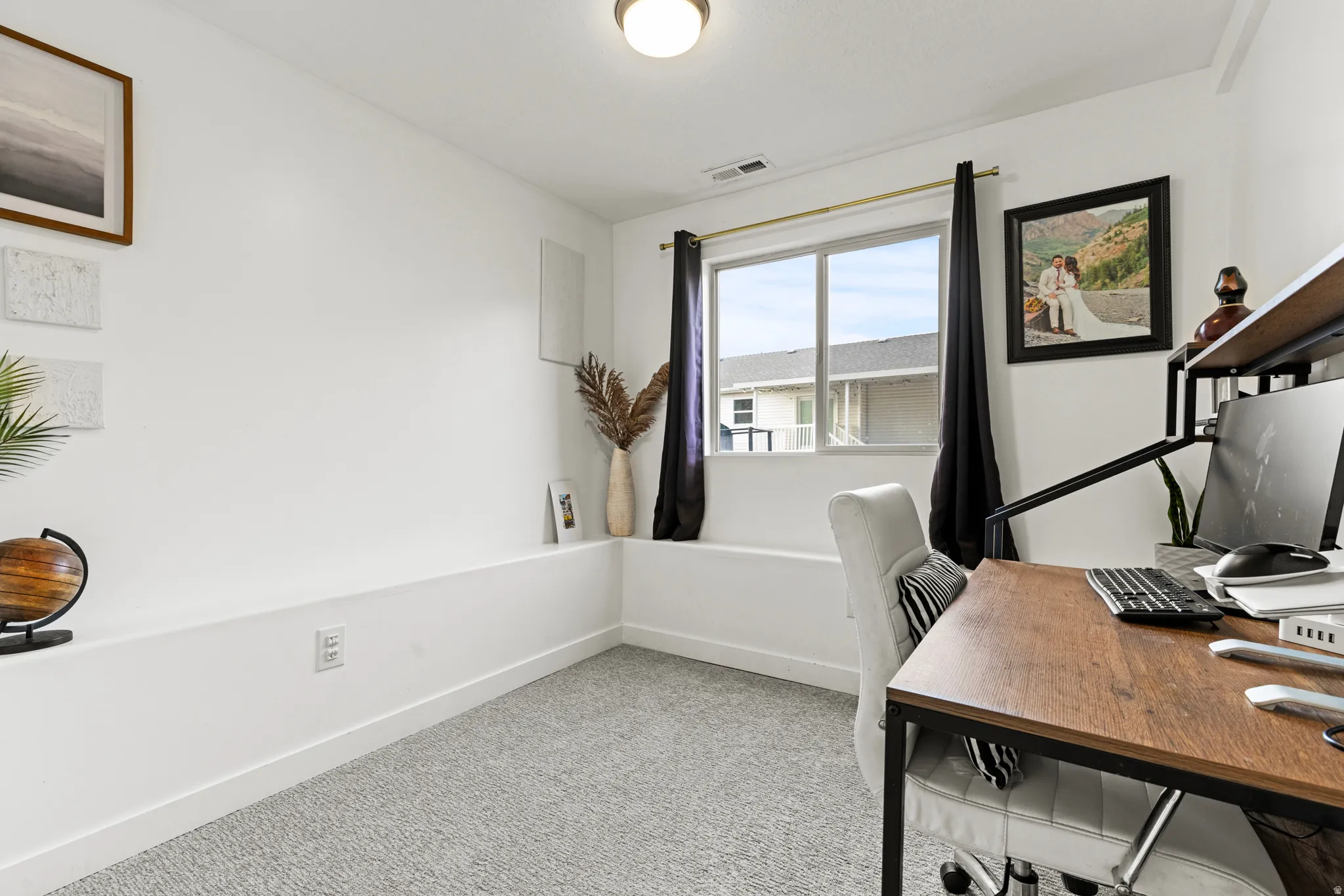 Office space featuring baseboards and light carpet