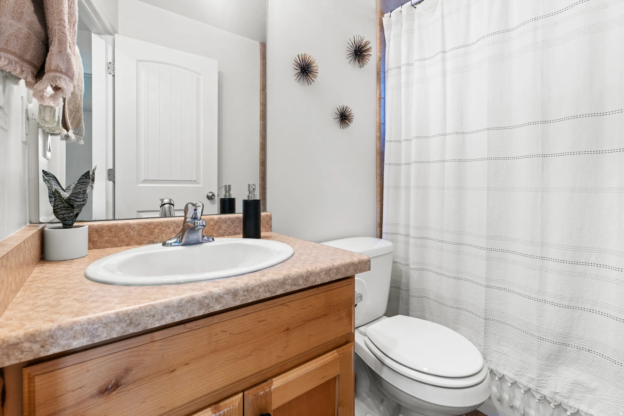 Bathroom with vanity and curtained shower