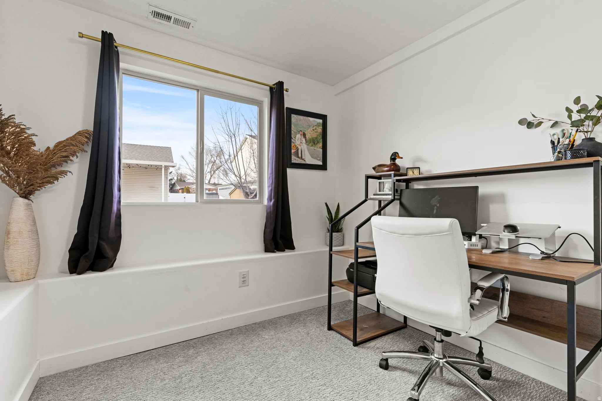 Office featuring light carpet and baseboards