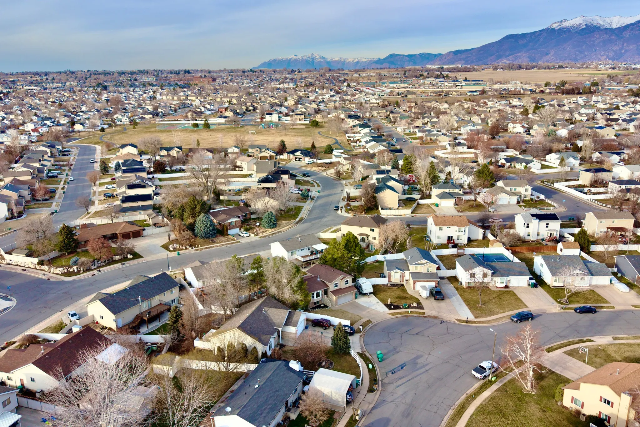 Aerial perspective of suburban area featuring a mountain backdrop