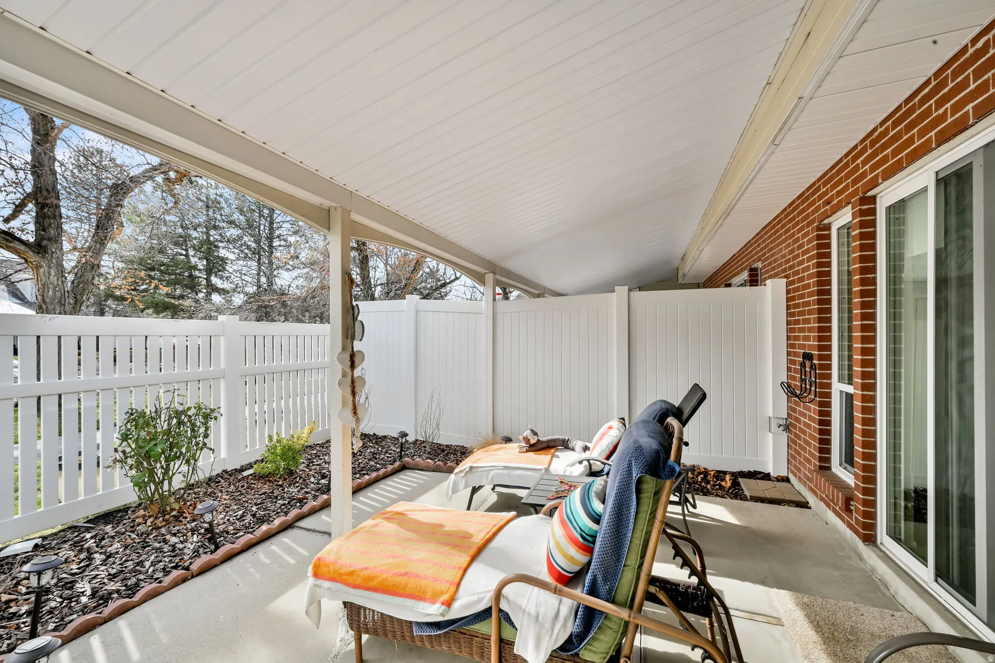 Fenced backyard with a patio area