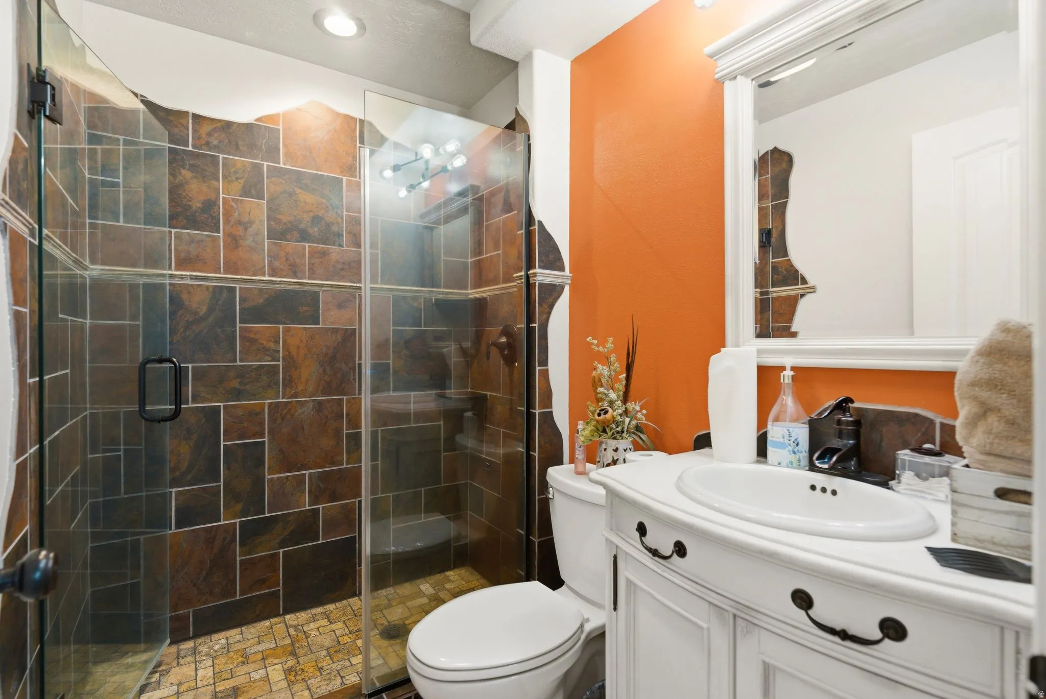 Bathroom featuring vanity and a shower stall