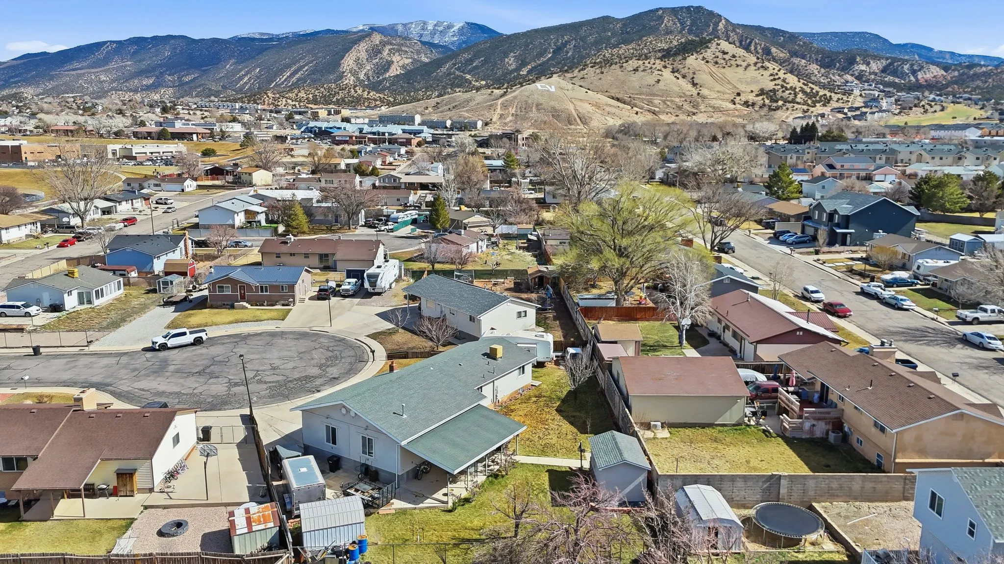 Aerial perspective of suburban area featuring a mountain backdrop