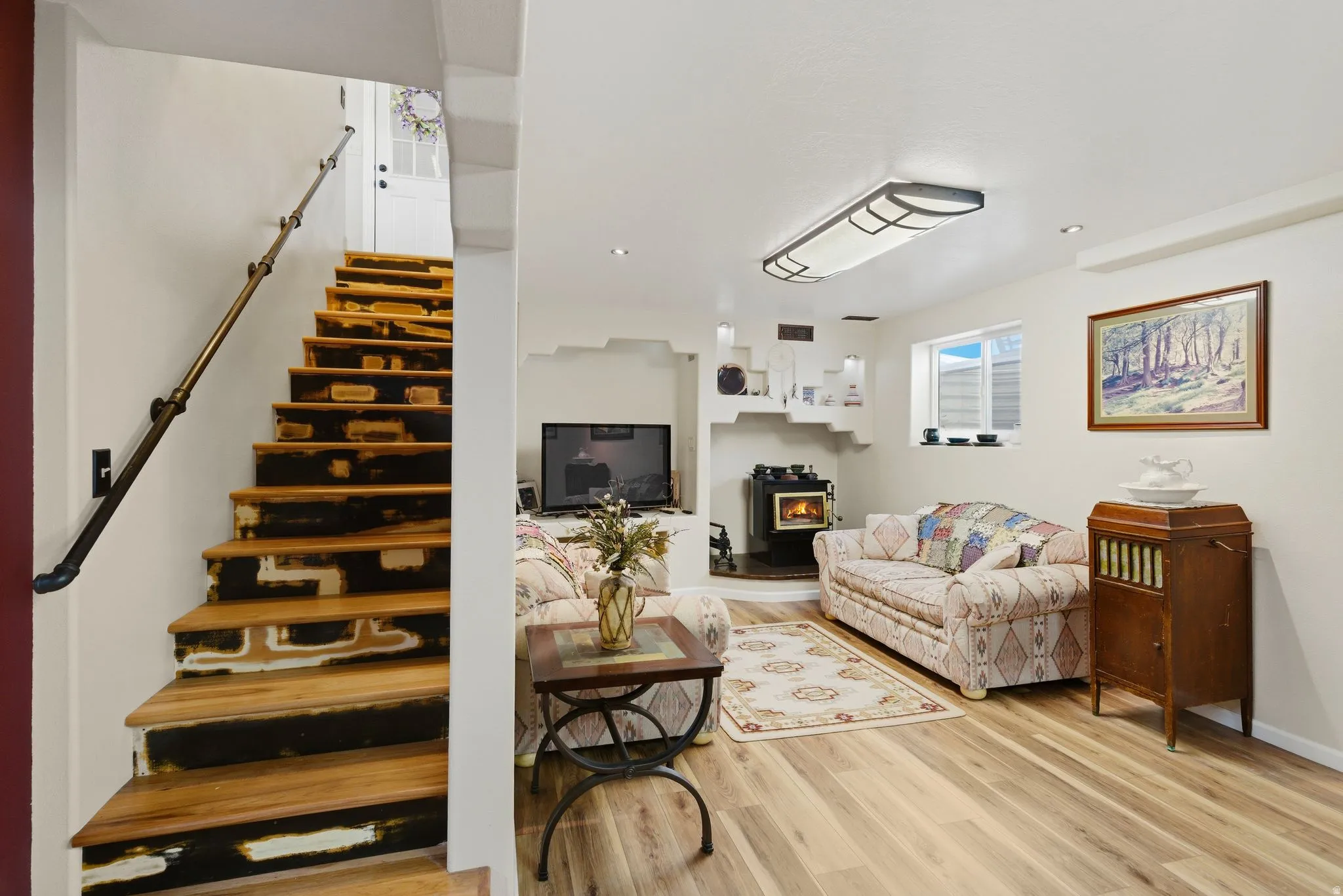 Living room with stairs and light wood-type flooring