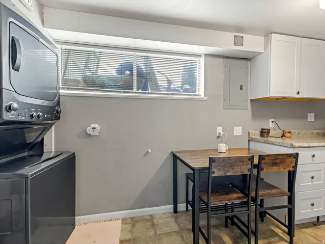 Laundry area with stacked washer and dryer.