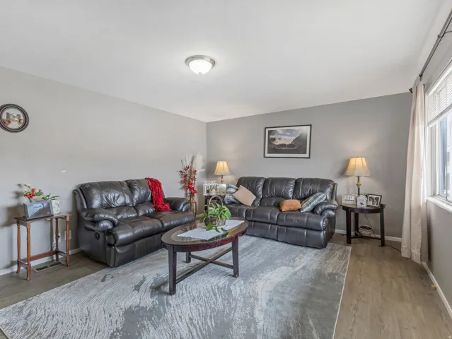 Living area with wood finished floors and baseboards