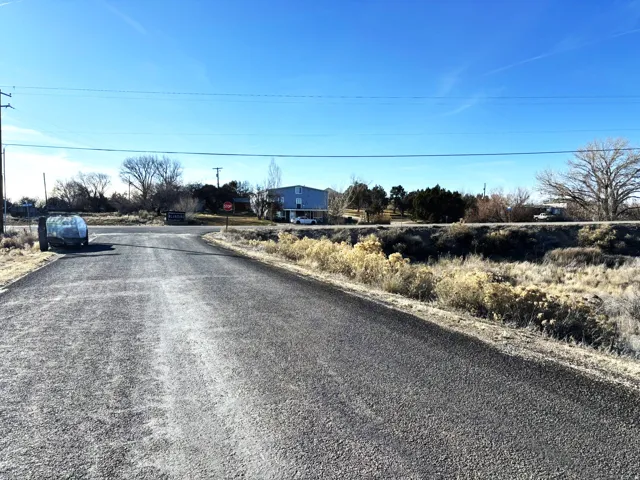 View of asphalt street with traffic signs