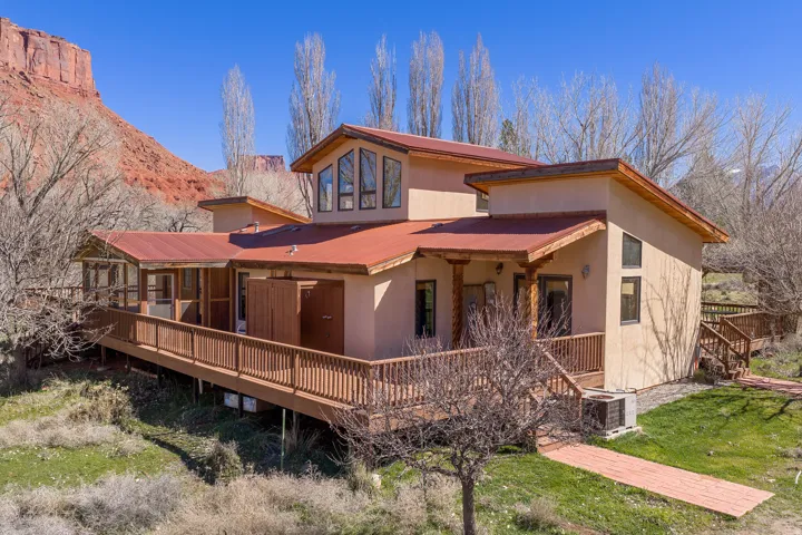 Back of house with large deck.