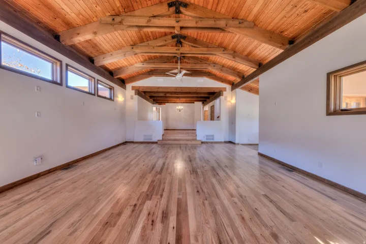 living room, wood ceiling with exposed beams and oak wood flooring