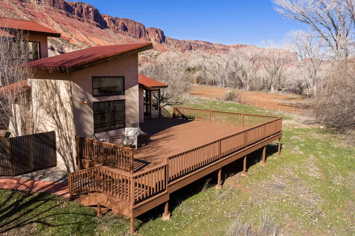 Large wrap around deck with a view of the back yard.