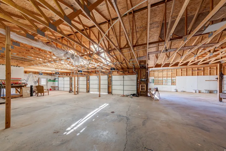 Garage with overhead storage space.