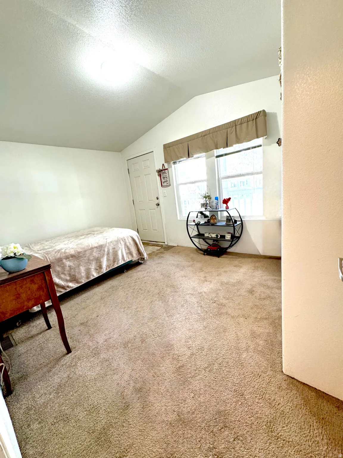 Bedroom with light colored carpet