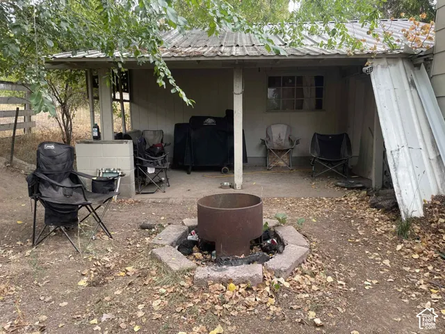 Rear view of house with a metal roof and a patio