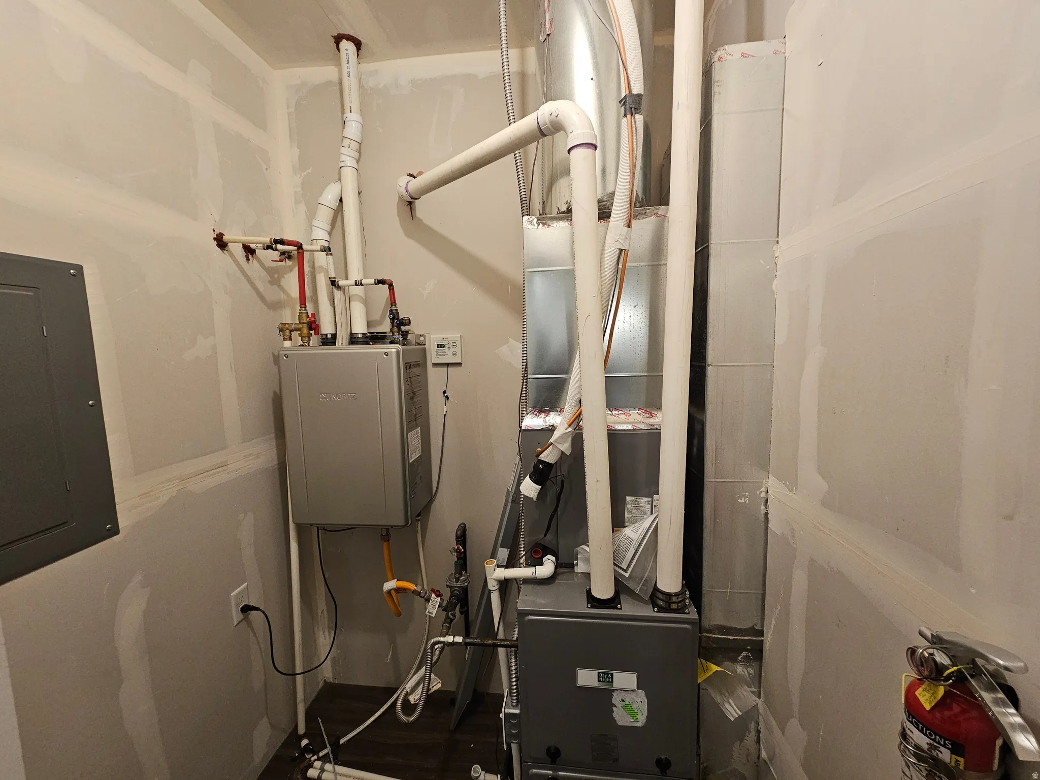 Utilities featuring electric panel, heating unit, and water heater