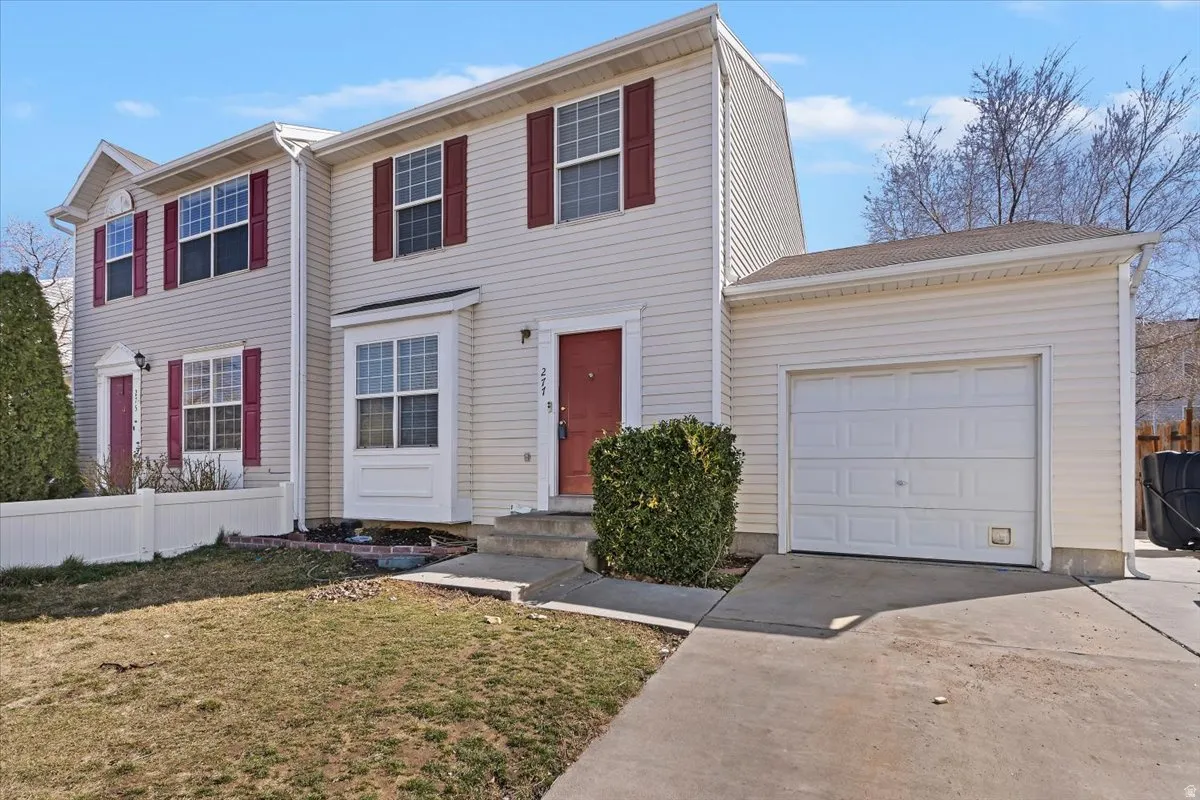 Twin house featuring concrete driveway, a garage, and entry steps