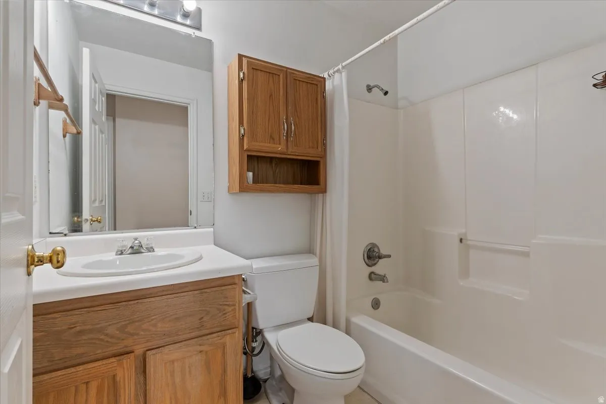 Bathroom featuring vanity and shower / bath combo