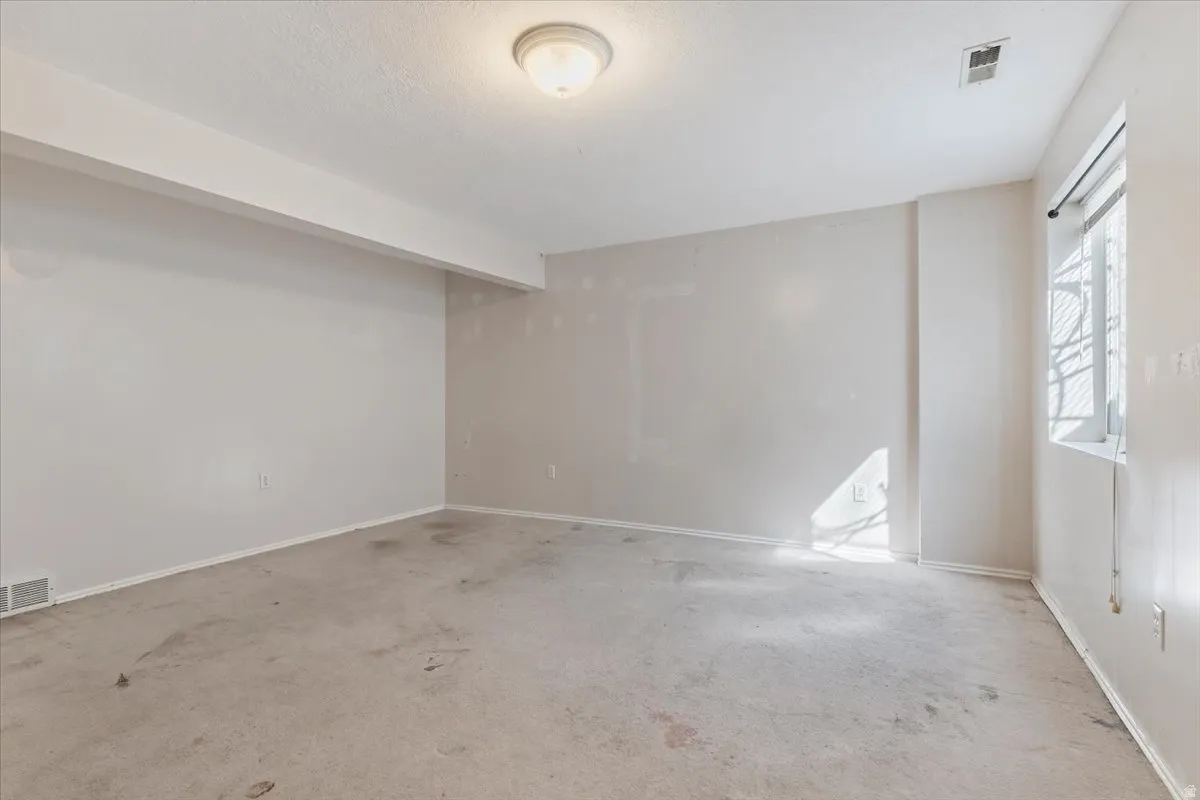 Unfurnished room with baseboards and carpet