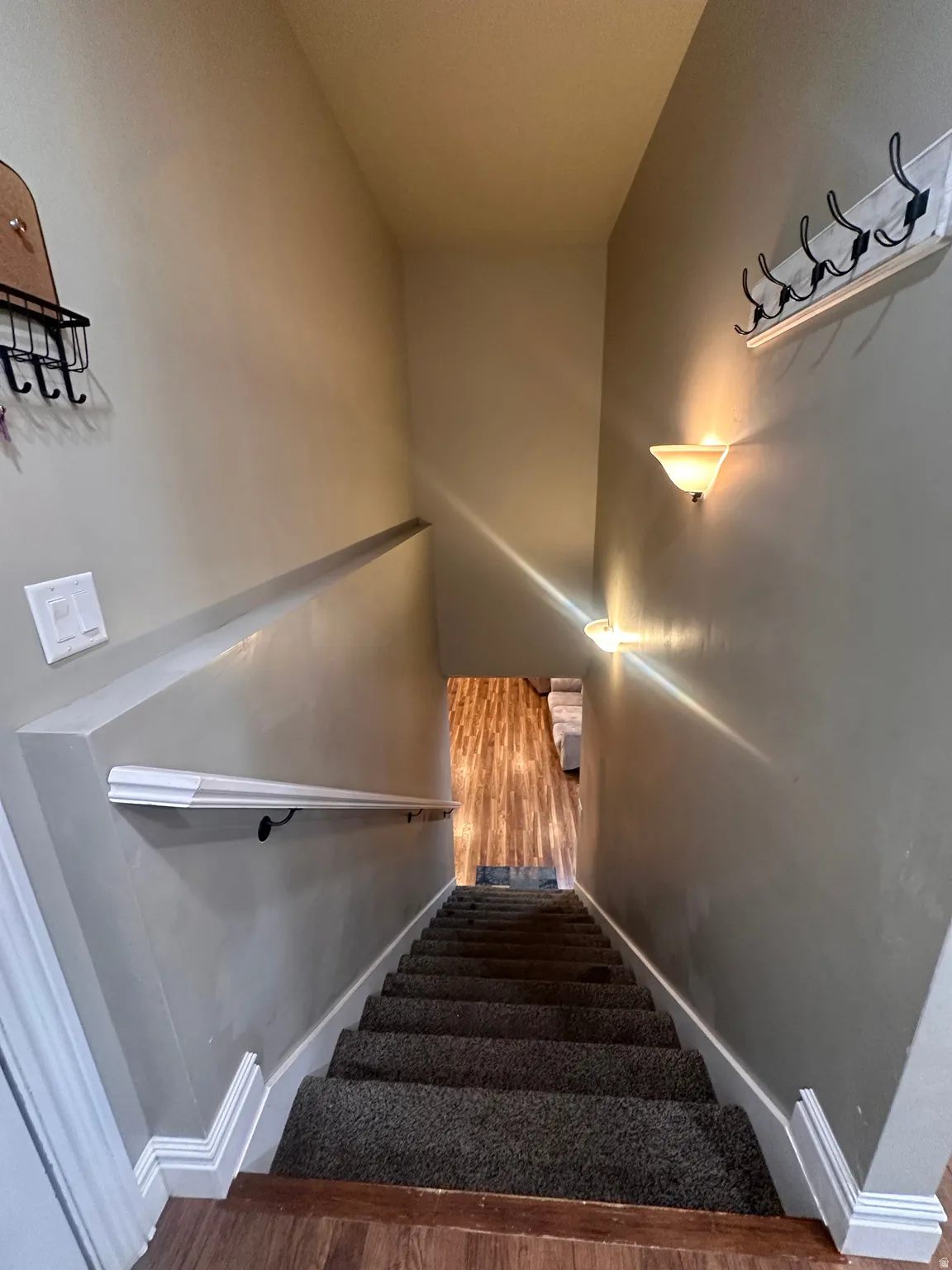 Stairway featuring baseboards and wood finished floors