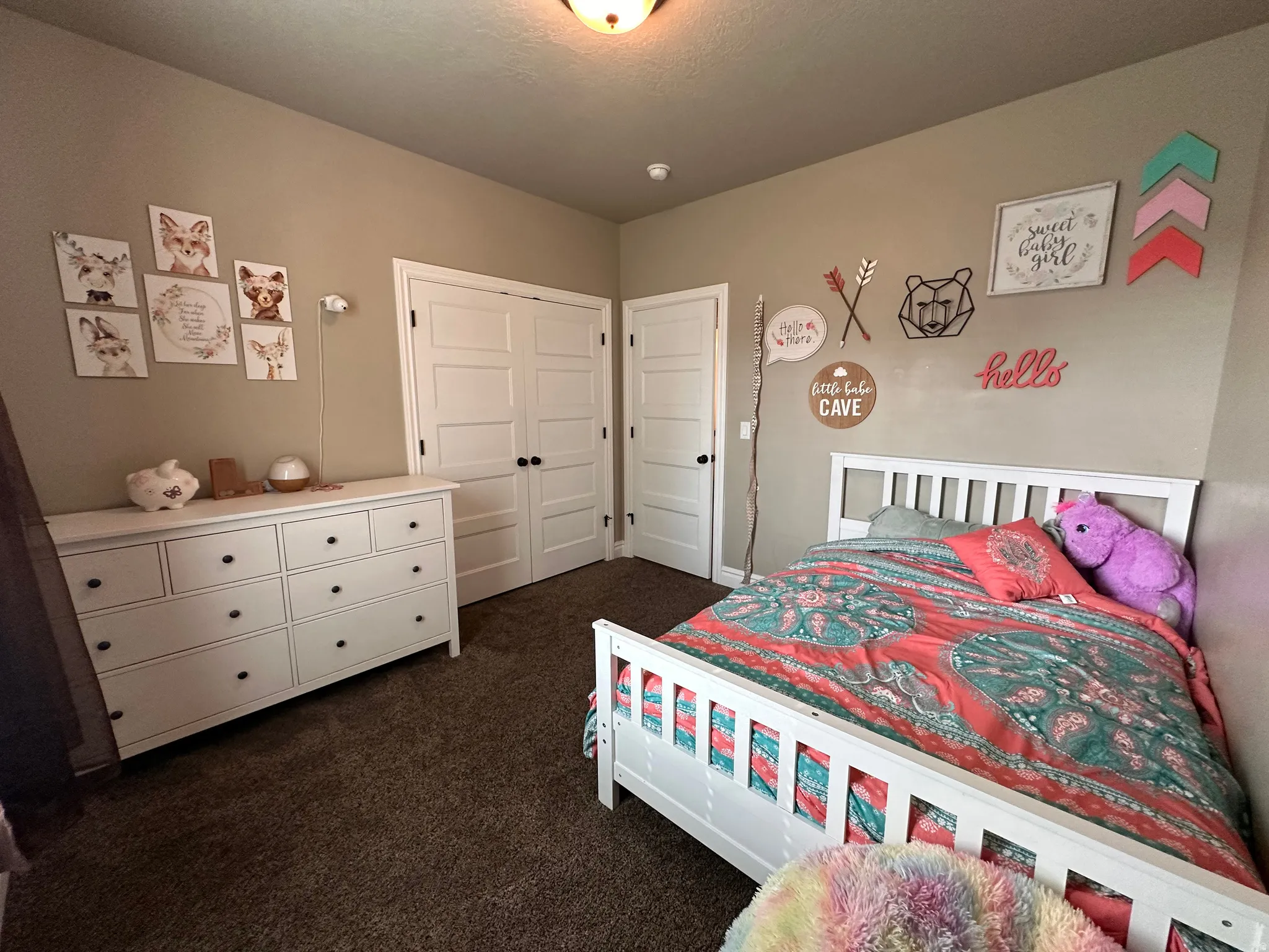 Bedroom with dark carpet and a closet