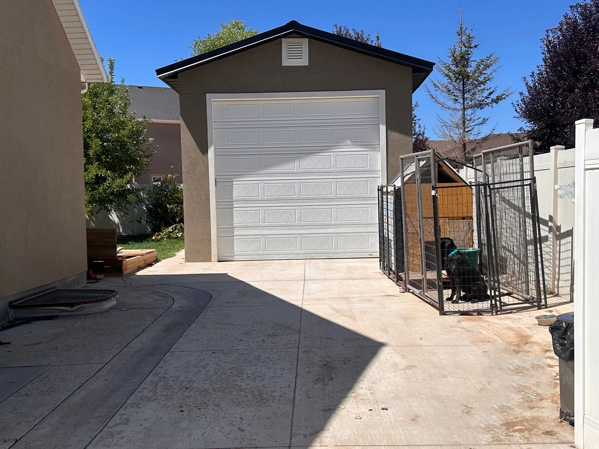 Detached garage with concrete driveway and a gate