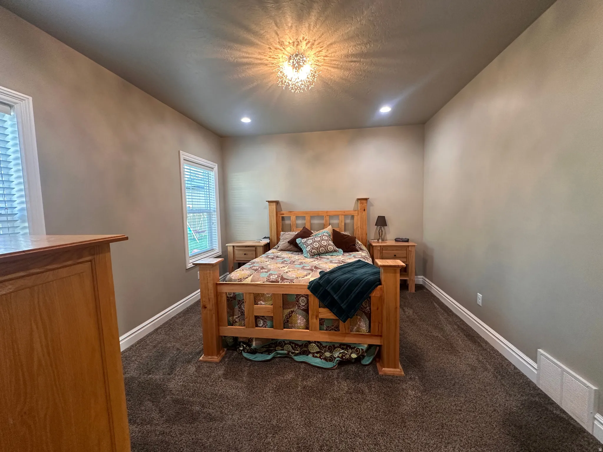 Bedroom featuring dark carpet and recessed lighting