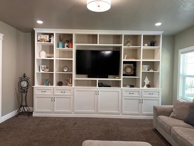 Living room featuring dark carpet, recessed lighting, and a textured ceiling