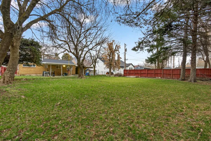 Fenced backyard with a patio area