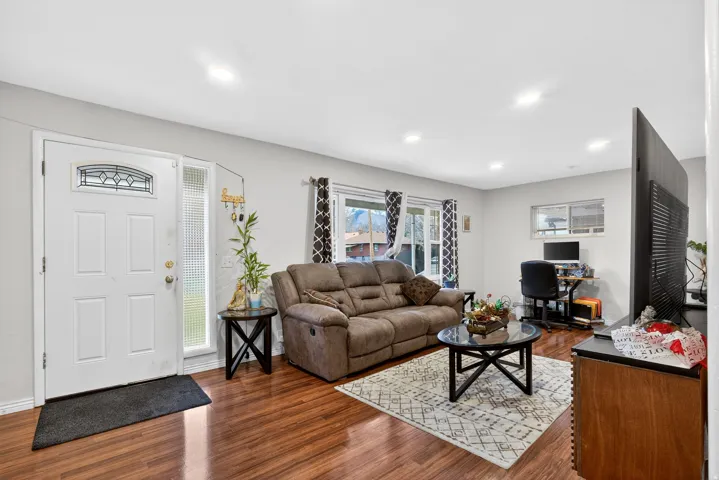 Living room featuring dark wood-style flooring, a desk, and recessed lighting