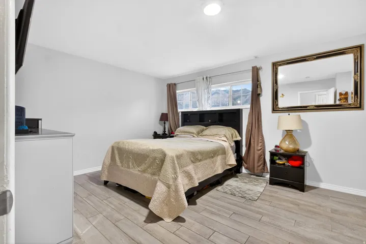 Bedroom with light wood-style floors and baseboards