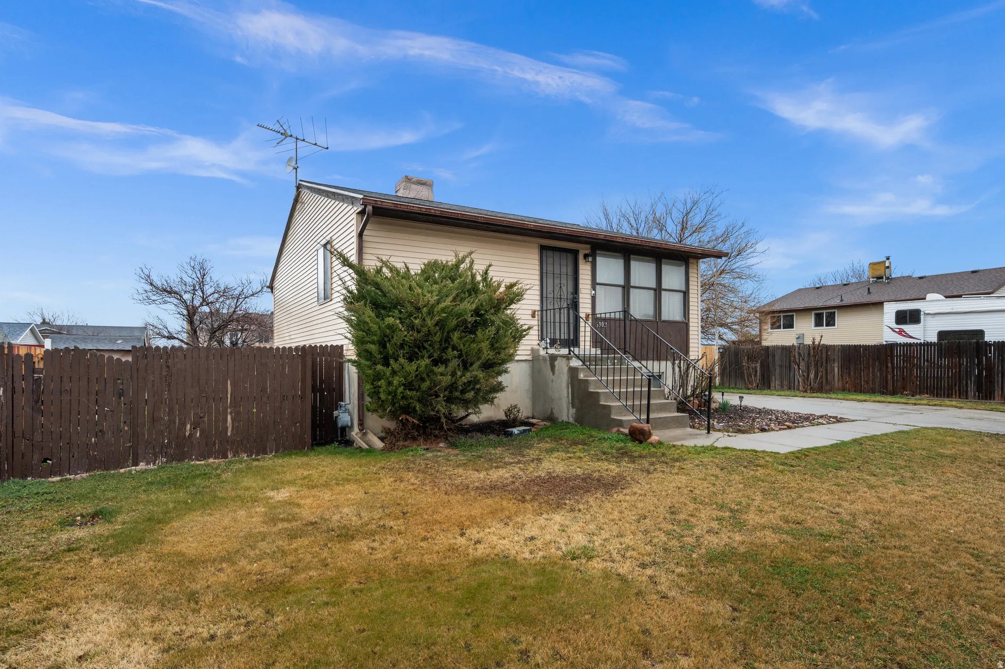 View of front of house with a chimney from West (fence being replaced)