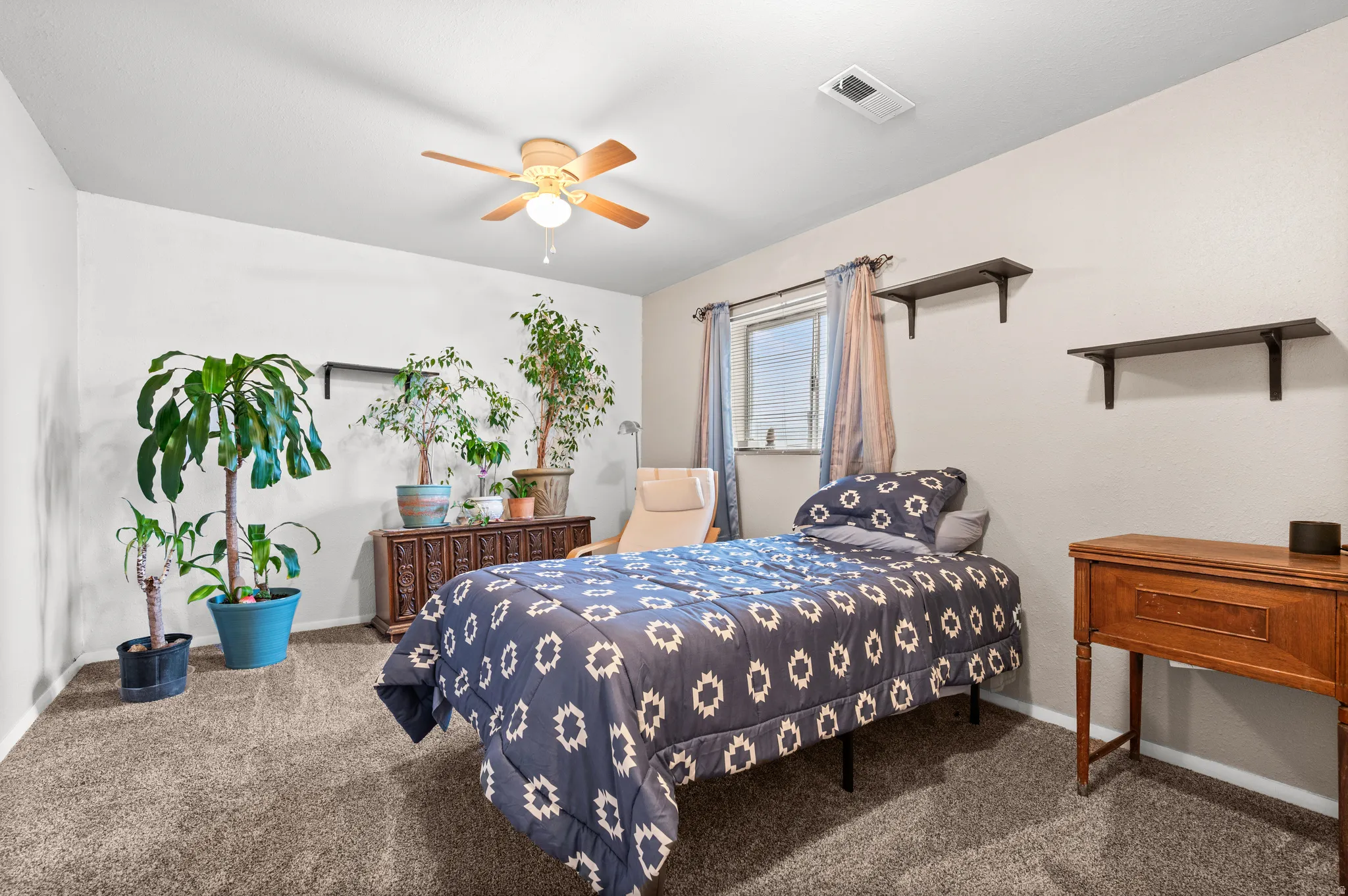 Large bedroom featuring carpet and ceiling fan