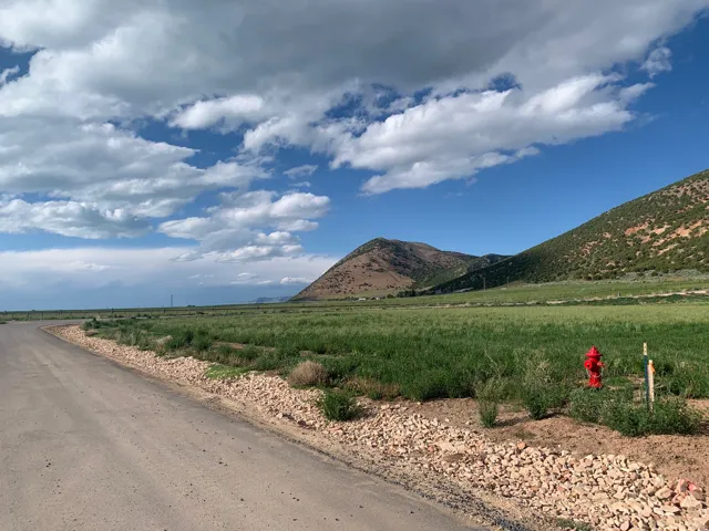 View of mountain background featuring rural landscape