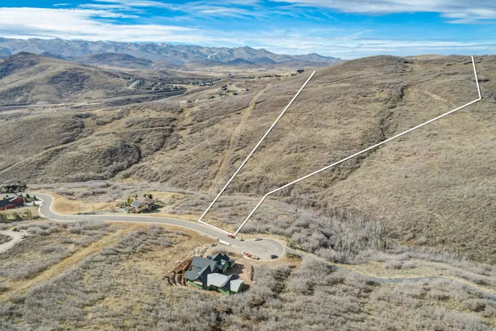 Overview of rural landscape featuring property parcel outlined and a mountainous background