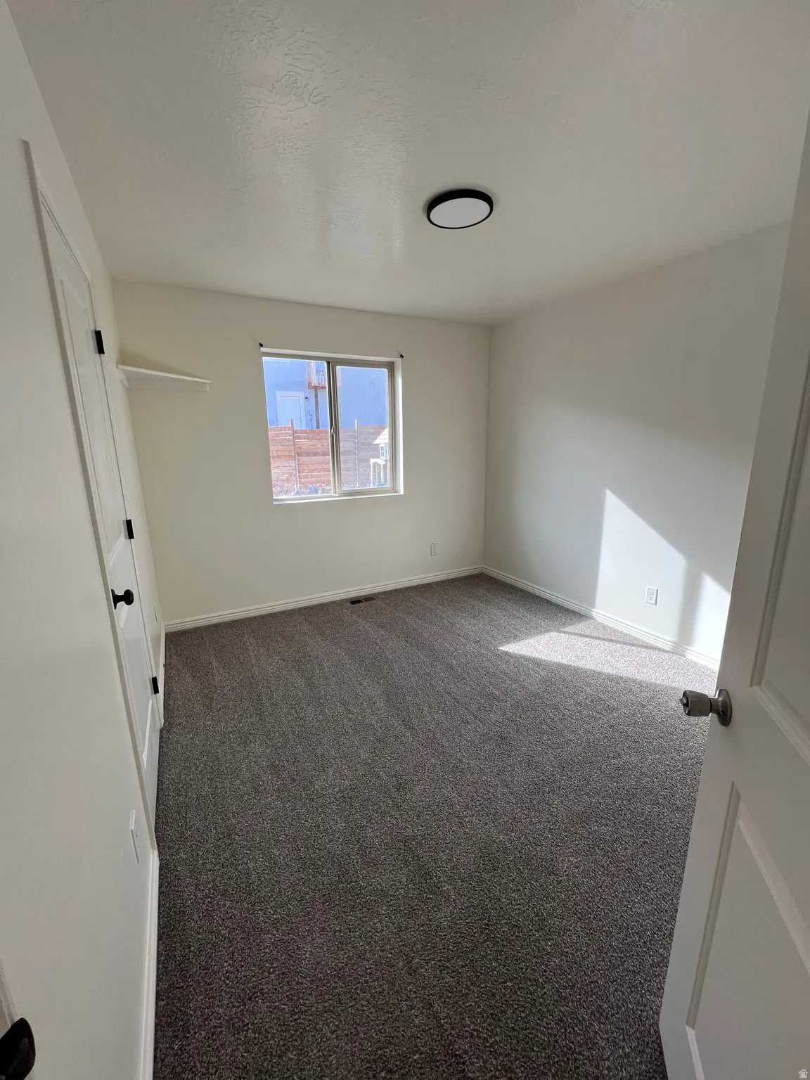 Unfurnished bedroom featuring baseboards and carpet flooring