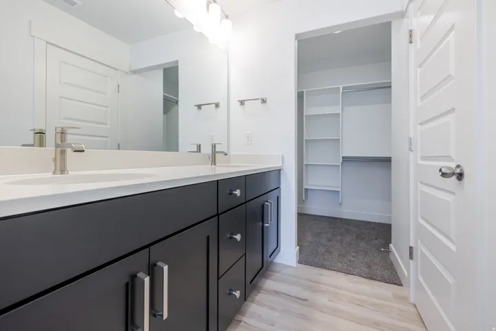 Dual vanity with a stone countertop and undermount sinks