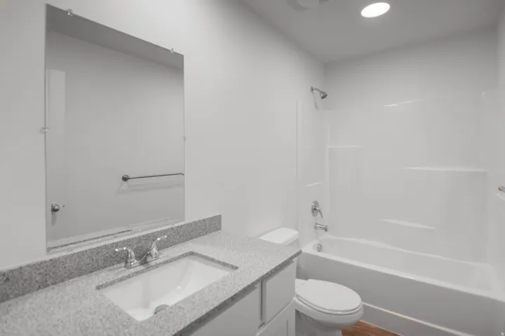 Bathroom featuring vanity, shower / tub combination, and recessed lighting