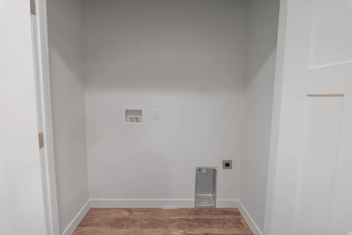 Laundry room featuring washer hookup, wood finished floors, and electric dryer hookup