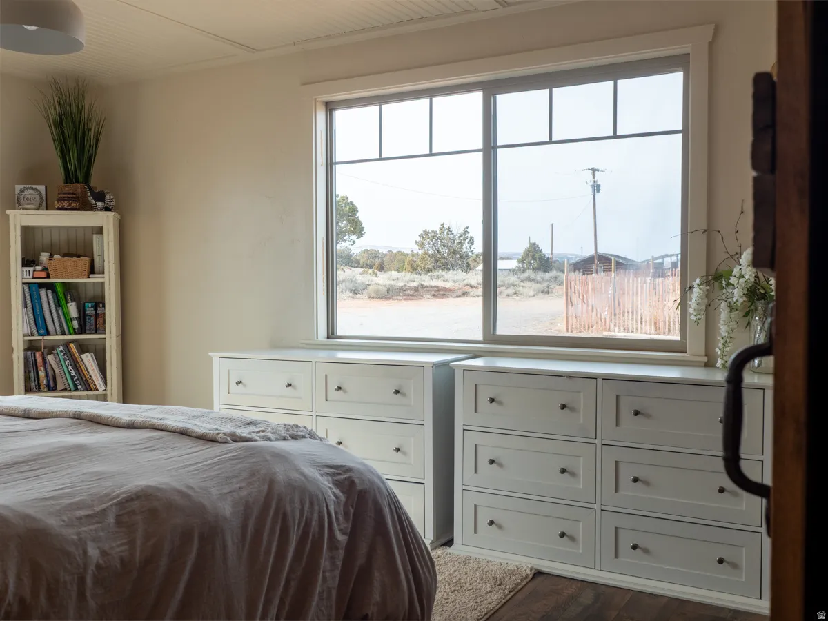 Bedroom with dark wood-style flooring