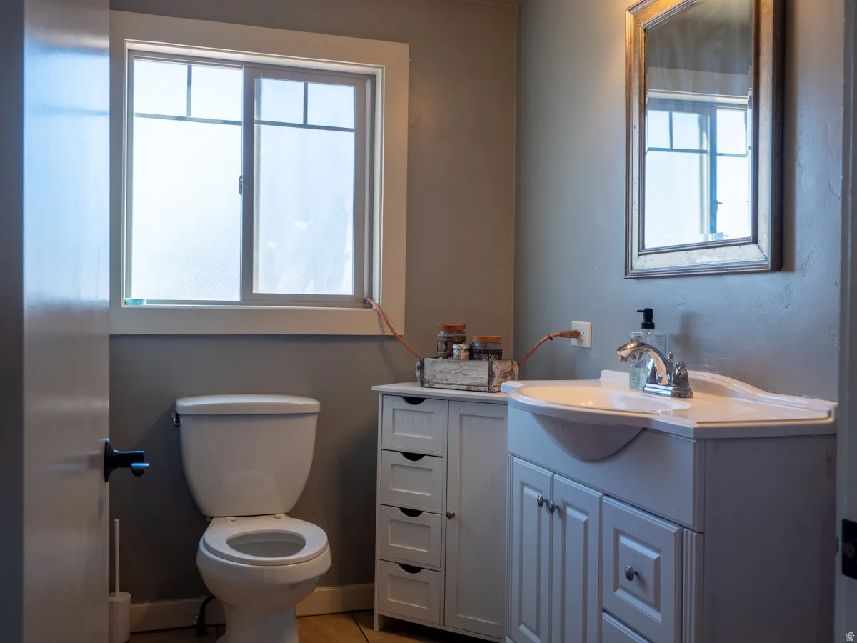 Half bath with vanity and light tile patterned floors