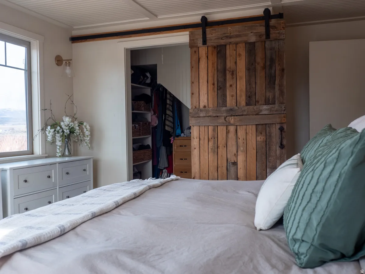 Bedroom featuring a barn door and a closet