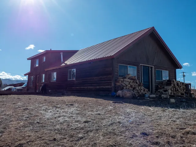 View of home's exterior with a metal roof and log siding