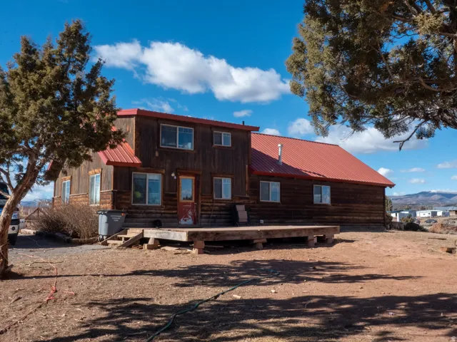 Rear view of house featuring a metal roof and a mountain view